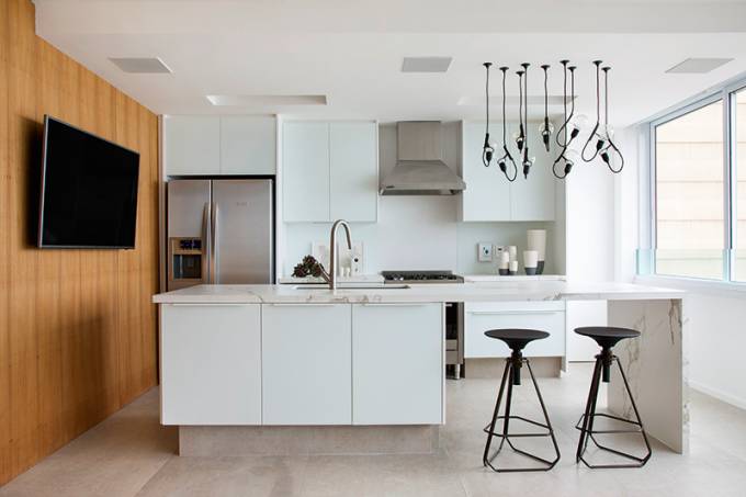 A reforma deste apartamento constru&iacute;do em 1970 privilegiou a integra&ccedil;&atilde;o entre os ambientes. Na cozinha, o principal objetivo era criar uma ambienta&ccedil;&atilde;o convidativa e funcional, incentivando a troca com o estar. Para conseguir este efeito, as principais solu&ccedil;&otilde;es encontradas pelo Studio Ro+Ca foram a implanta&ccedil;&atilde;o de um piso &uacute;nico de cer&acirc;mica entre os espa&ccedil;os e a utiliza&ccedil;&atilde;o de m&oacute;veis planejados