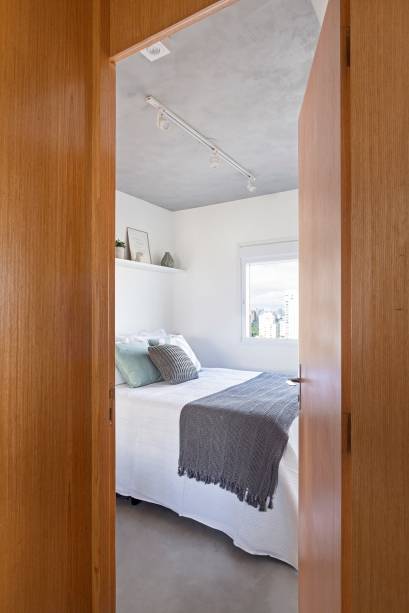 O quarto ganhou um armário em “L” que tem a função dupla de armário e divisória para a sala. O quarto ganhou um armário em “L” que tem a função dupla de armário e divisória para a sala.