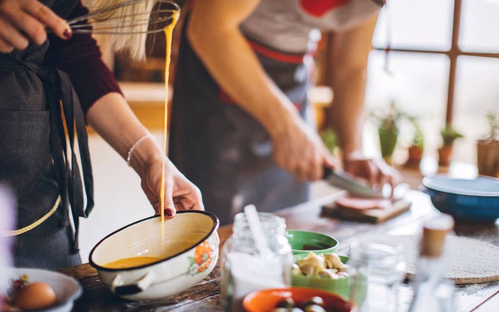 Woman beating eggs with whisk