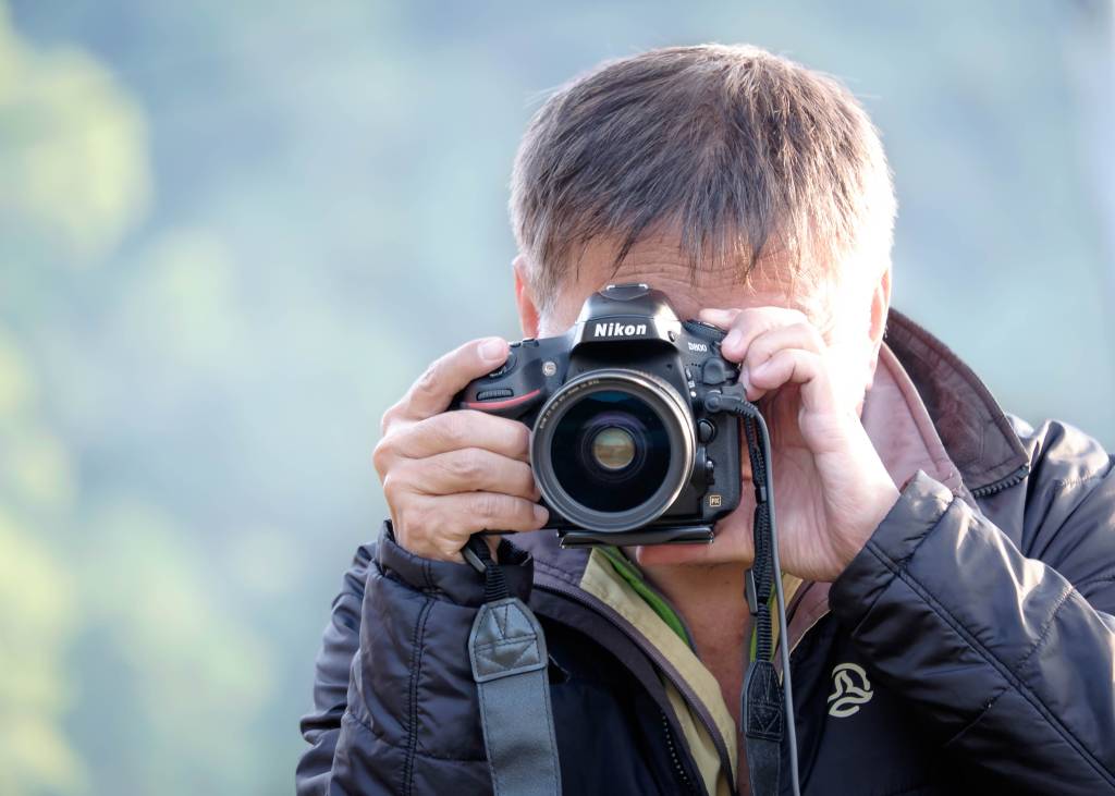 A photographer shooting with DSLR camera A photographer shooting with DSLR camera
