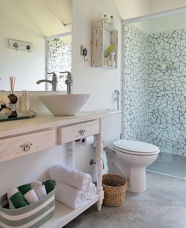 Um estilo de decoração mais afetiva se revela neste banheiro de uma casa de campo em Ibiúna, SP. Assinado pela arquiteta Beatriz Castanho, o projeto exibe elementos rústicos, como o aparador e a prateleira com pintura desgastada, o piso de cimento queimado e os caquinhos de azulejo (Arhus Alto Brilho Branco, de 32 x 57 cm, da Cecafi. C&C, R$ 11,90 o m²). Um estilo de decoração mais afetiva se revela neste banheiro de uma casa de campo em Ibiúna, SP. Assinado pela arquiteta Beatriz Castanho, o projeto exibe elementos rústicos, como o aparador e a prateleira com pintura desgastada, o piso de cimento queimado e os caquinhos de azulejo (Arhus Alto Brilho Branco, de 32 x 57 cm, da Cecafi. C&C, R$ 11,90 o m²).