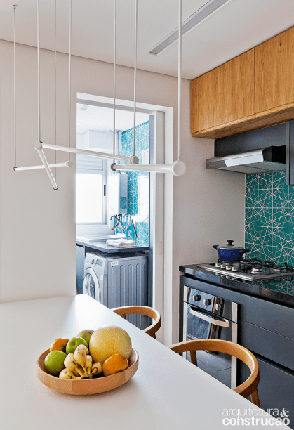 Na reforma, a &aacute;rea de servi&ccedil;o perdeu um trecho para a cozinha. Os revestimentos repetem-se nos dois ambientes.