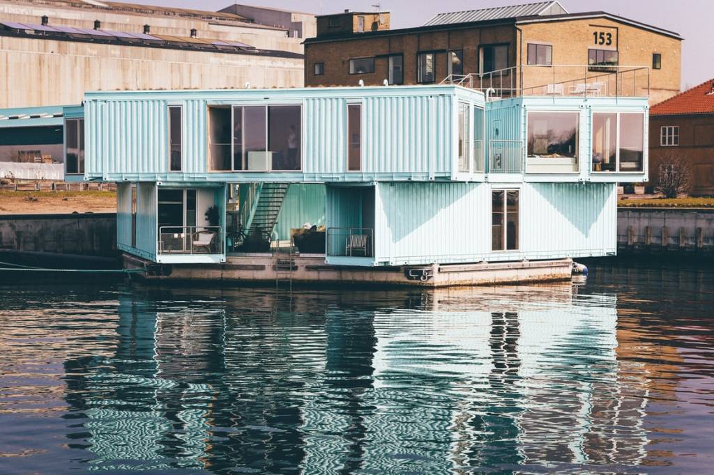 1-casa-container-custo-beneficios-sustentabilidade-casa-container-turquesa-a-beira-da-agua-unsplash-nick-karvounis