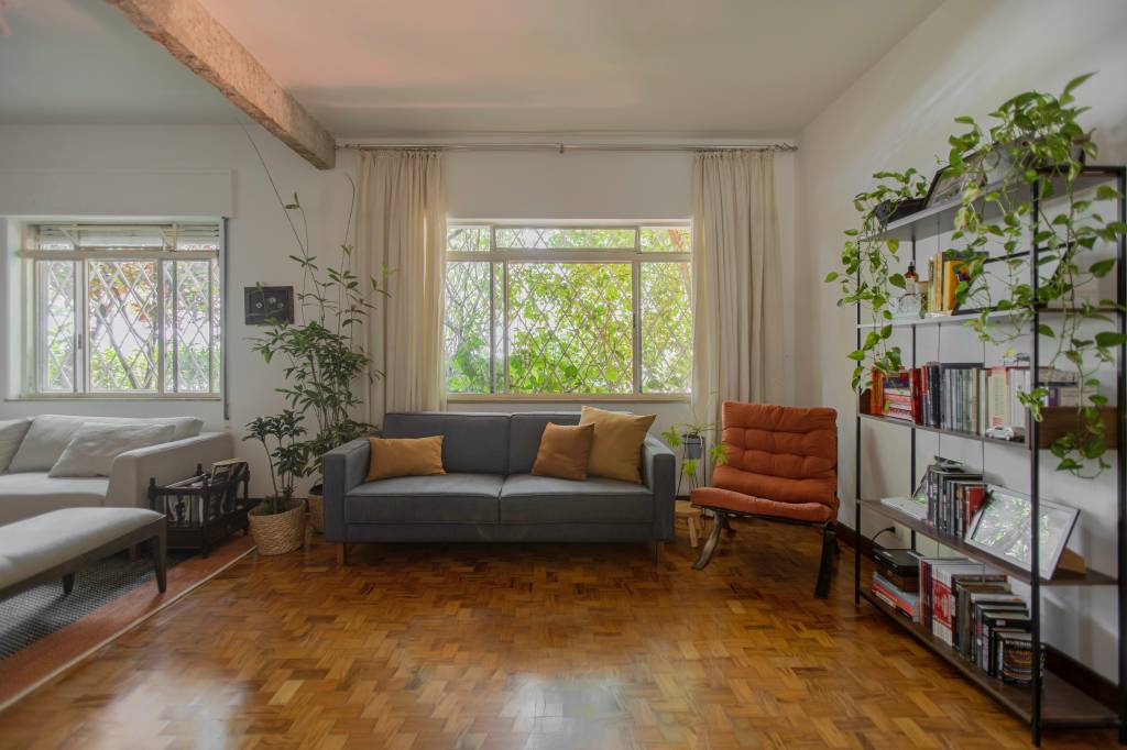 15-tijolo-concreto-e-madeira-deixam-ape-alugado-mais-aconchegante-anga-arquitetura-joao-paulo-prado Sala de estar com sofá cinza e poltrona laranja, janela no fundo