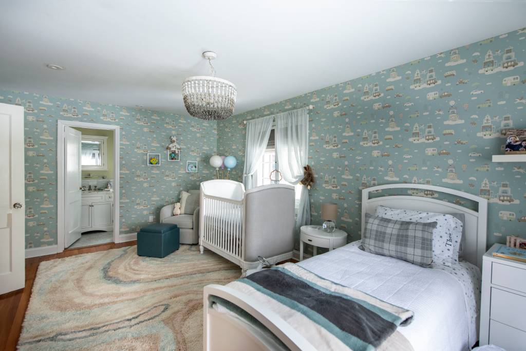 9-reforma-de-casa-de-1928-e-inspirada-pela-musica-de-bruce-springsteen Quarto de bebê com papel de parede azul, berço e cama brancos