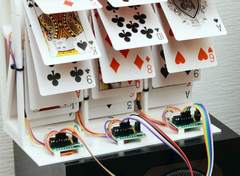 Designer cria um relógio mecânico com cartas Designboom (1) Cartas de baralho presas a rodas.
