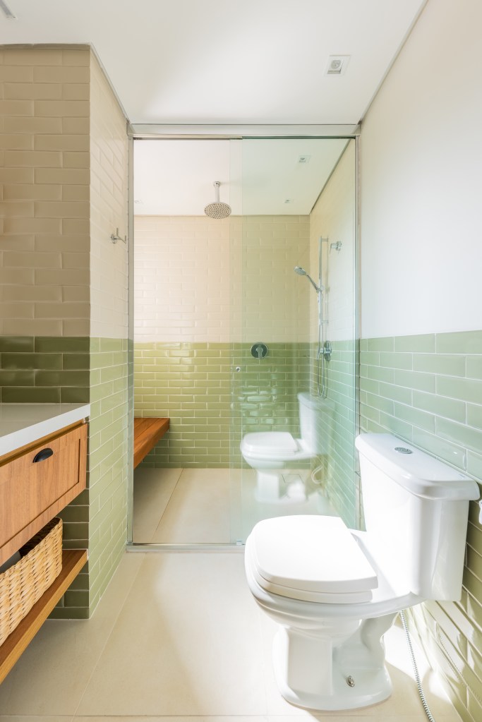 Banheiro com meia parede de azulejos verdes