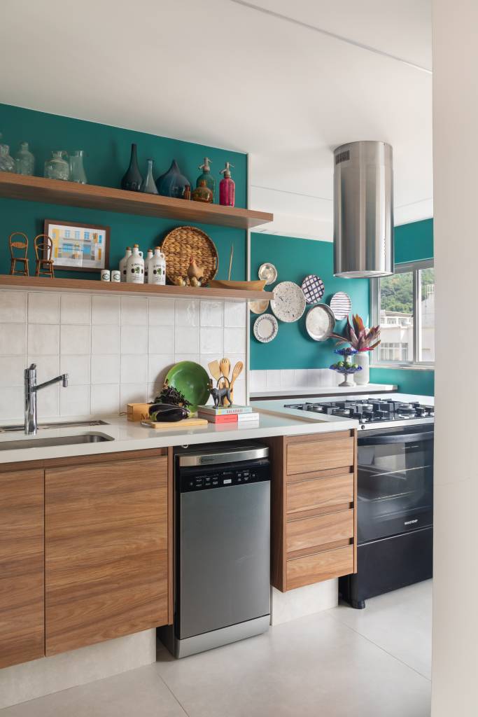 azul-verde-marcam-ape-81m-cozinha-integrada-bancada-espacosa-ketlein-amorim-11-cozinha Cozinha com parede verde, backsplash de azulejos brancos e coifa.