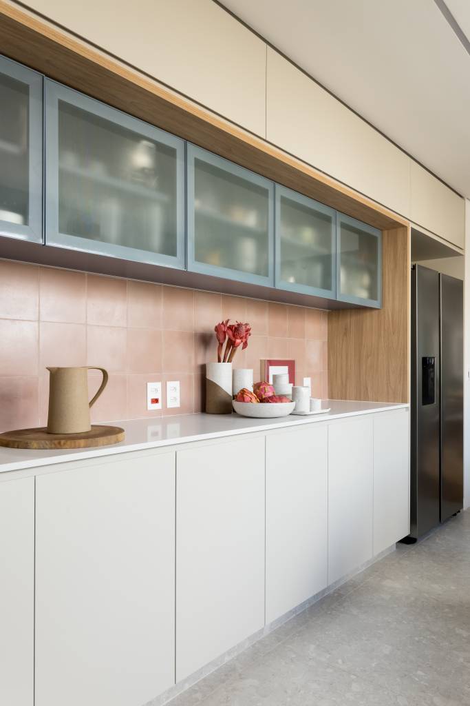 Apto Brooklin Novo Apê de 180 m² ganha azul na marcenaria e nos revestimentos da cozinha. Projeto de Studio LAK. Na foto, bancada branca, armário com porta de vidro canelado.