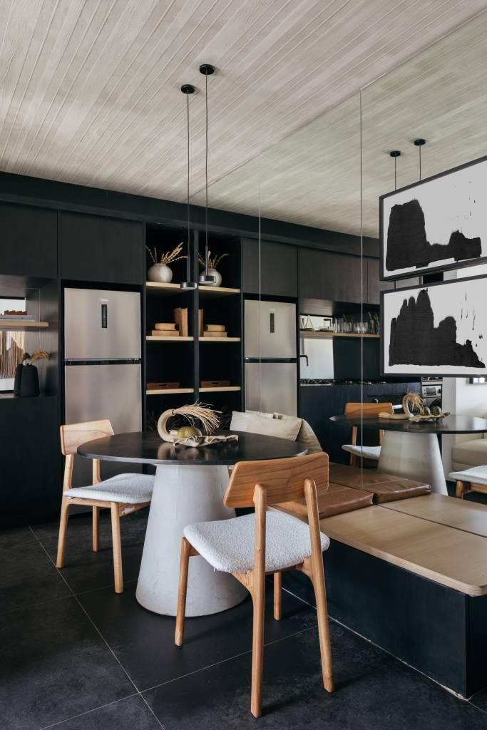 ape-73-m-marcenaria-ebanizada-piso-de-porcelanato-preto-studio-leandro-neves-03-sala Apê de 73 m² tem marcenaria ebanizada e piso de porcelanato preto. Projeto de Studio Leandro Neves. Na foto, sala, parede preta, teto de concreto, sofá branco, mesa redonda, cozinha integrada.