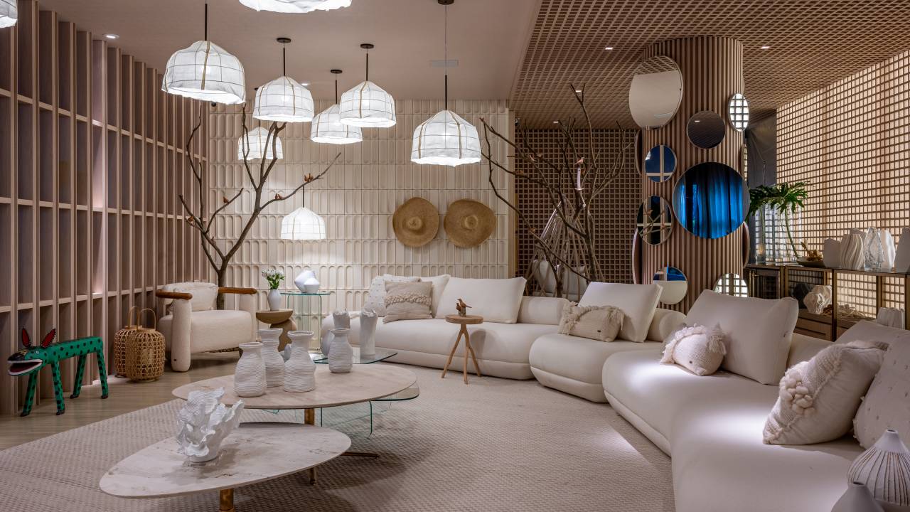 Jogo de luz e sombra: madeiras em muxarabi são destaque neste ambiente. Projeto de Carla Felippi. Na foto, sala com luminárias, peças de decoração e sofá extenso