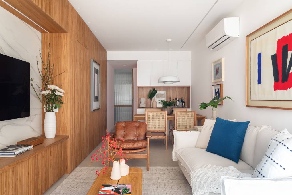 Novo lar de mãe e filha tem espaço de home office e estante de marcenaria ripada