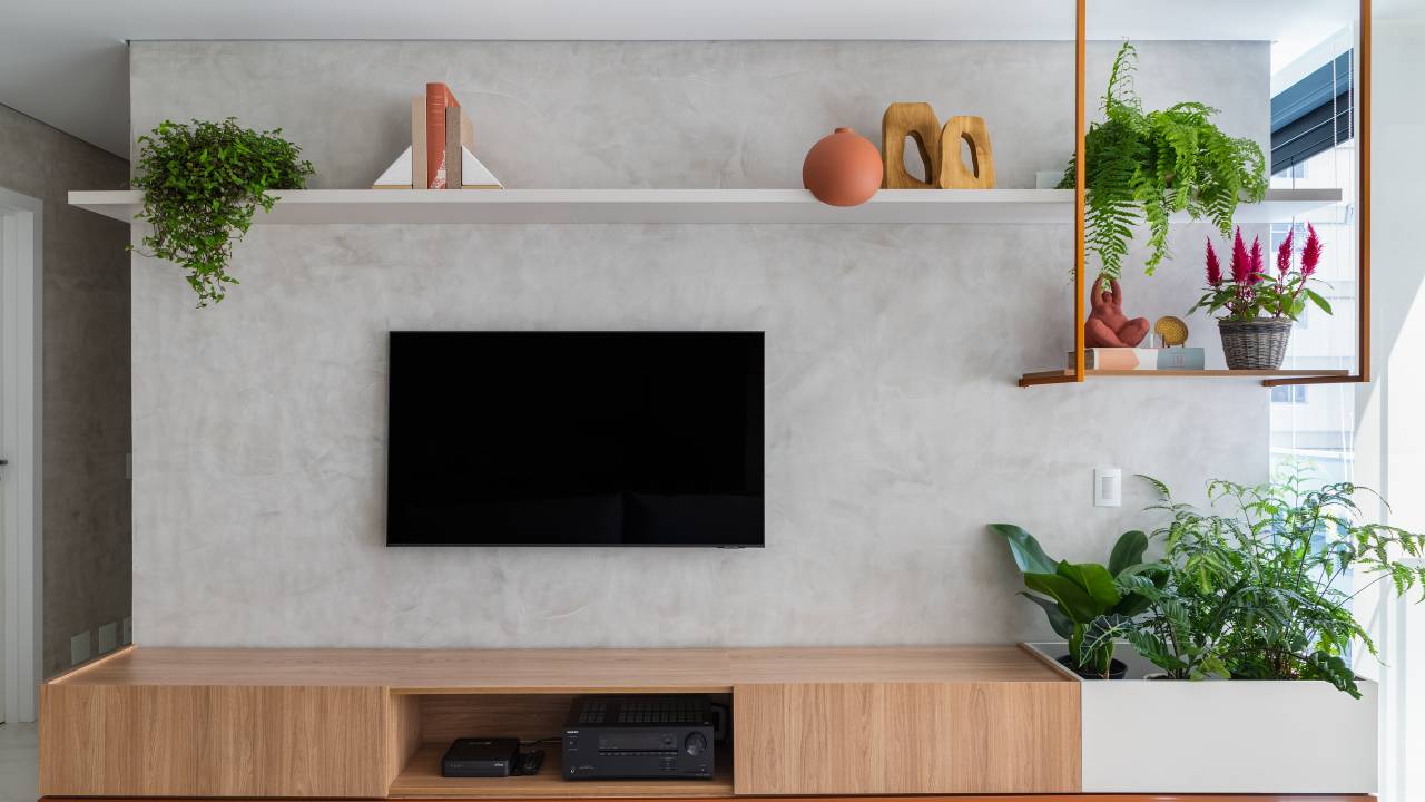 Apartamento com varanda integrada tem vasos diretamente na marcenaria. Projeto de Flávia Prata.