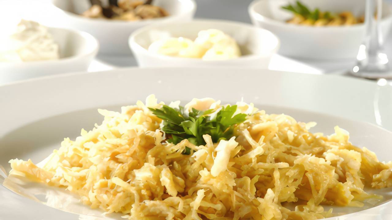 Imagem mostrando um prato de Bacalhau Dourado, uma especialidade do chef português Valderi Gomes. O bacalhau é servido em uma apresentação apetitosa, com batatas palha crocantes, ovos batidos e alho, demonstrando a riqueza da culinária portuguesa e a leveza do prato.