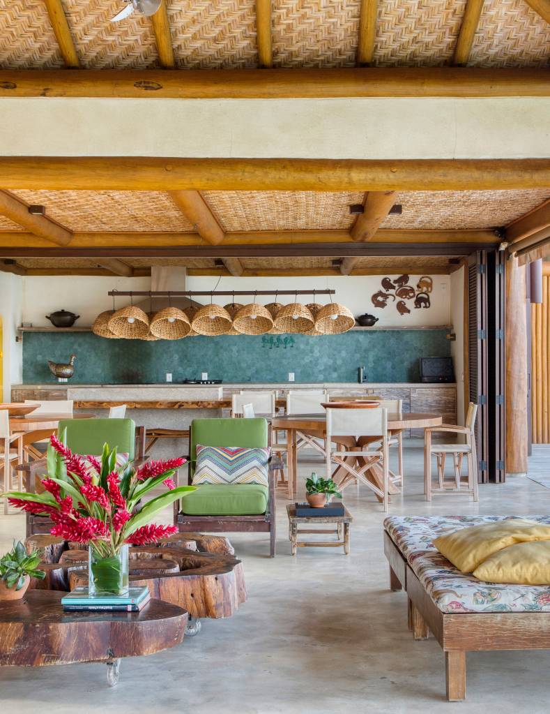 Linda casa de campo tem estrutura de eucalipto e décor rústico chic. Projeto de Solange Calio. Na foto, sala de estar, área gourmet integrada com área externa.