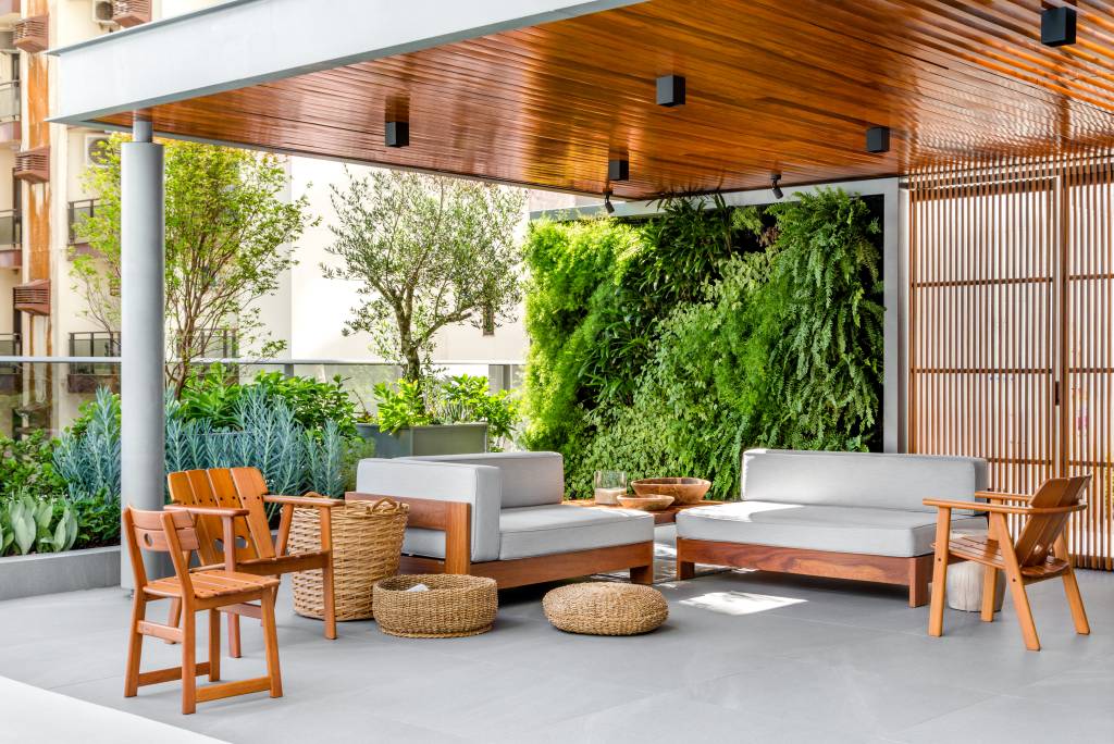 Terraço de apartamento tem paisagismo com jardim vertical