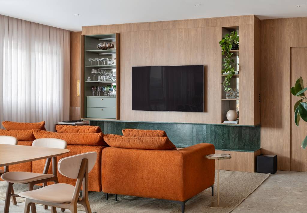 Lareira em mármore verde e toques musicais se destacam em apartamento de 170 m²
