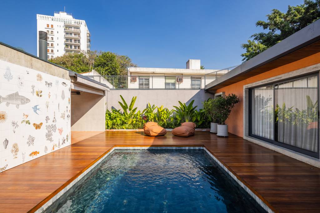 Volume de concreto integra banheiro, closet e área gourmet nesta casa