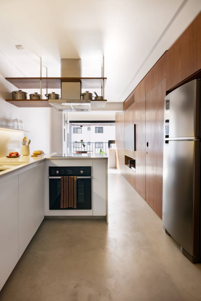 Apê pequeno tem home office verde e estiloso oculto na marcenaria. Projeto de COTA 760 Arquitetura.